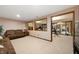 Spacious finished basement with adjacent workout area, striped wallpaper, and comfortable sofa at 6575 Robin Hood Dr, Indianapolis, IN 46227