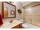 Cozy bathroom featuring wooden vanity, toilet, and shower with glass doors at 6575 Robin Hood Dr, Indianapolis, IN 46227