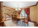 Formal dining room with elegant lighting, hardwood floors, and natural light at 6575 Robin Hood Dr, Indianapolis, IN 46227