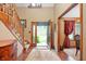 Inviting foyer with wood floors, staircase, and plenty of natural light at 6575 Robin Hood Dr, Indianapolis, IN 46227