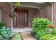 Inviting front entrance with a charming brick facade and colorful, landscaped garden beds at 6575 Robin Hood Dr, Indianapolis, IN 46227