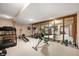 Home gym with workout equipment, mirrored wall, and neutral carpet for fitness enthusiasts at 6575 Robin Hood Dr, Indianapolis, IN 46227
