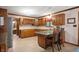 Efficient kitchen featuring wood cabinets, breakfast bar, and updated appliances at 6575 Robin Hood Dr, Indianapolis, IN 46227