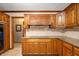 Kitchen with wood cabinets, granite countertops, and a tile backsplash at 6575 Robin Hood Dr, Indianapolis, IN 46227