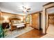 Bedroom featuring wooden trim, a ceiling fan, and an adjacent bathroom at 6575 Robin Hood Dr, Indianapolis, IN 46227