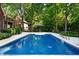 Backyard pool, patio area, and lush landscaping offer a private and serene outdoor retreat at 6575 Robin Hood Dr, Indianapolis, IN 46227