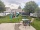 Spacious backyard with a playset, trampoline, and outdoor seating area at 6604 Heritage Hill Dr, Indianapolis, IN 46237