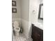 A remodeled half-bathroom featuring mosaic tiled floors and a dark wood vanity with white countertop at 6604 Heritage Hill Dr, Indianapolis, IN 46237