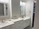 Bright bathroom with double sinks, gray patterned floors and vanity storage at 6604 Heritage Hill Dr, Indianapolis, IN 46237