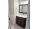 Bathroom with new vanity featuring marble countertop, white subway tile wainscoting, and patterned tile flooring at 6604 Heritage Hill Dr, Indianapolis, IN 46237