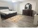 Spacious bedroom features a bed, wood-look flooring and plenty of natural light at 6604 Heritage Hill Dr, Indianapolis, IN 46237