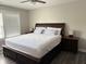 Bright bedroom with a large window, dark wood furniture, and neutral decor at 6604 Heritage Hill Dr, Indianapolis, IN 46237
