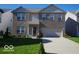 Charming two-story home with a well-maintained lawn, brick facade, attached two-car garage, and welcoming entryway at 6604 Heritage Hill Dr, Indianapolis, IN 46237
