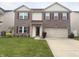 Charming two-story brick home featuring a two-car garage and well-maintained front lawn at 6604 Heritage Hill Dr, Indianapolis, IN 46237