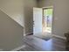 Bright foyer with hardwood floors and an open view to the outdoors through the front door at 6604 Heritage Hill Dr, Indianapolis, IN 46237