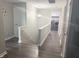 A second floor hallway view of the stairwell and the laundry room featuring new, side-by-side washer and dryer appliances at 6604 Heritage Hill Dr, Indianapolis, IN 46237