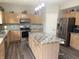 A kitchen featuring stainless steel appliances, a center island, and wood cabinets with complementing countertops at 6604 Heritage Hill Dr, Indianapolis, IN 46237