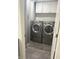A clean and organized laundry room featuring modern washer and dryer appliances and storage cabinets at 6604 Heritage Hill Dr, Indianapolis, IN 46237