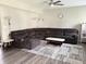Cozy living room featuring a large sectional sofa, ceiling fan, and hardwood floors at 6604 Heritage Hill Dr, Indianapolis, IN 46237