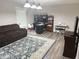 Comfortable living room with a brown sofa, work space and bright natural light at 6604 Heritage Hill Dr, Indianapolis, IN 46237