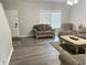 Comfortable living room with hardwood floors, a neutral color scheme, and ample natural light at 6604 Heritage Hill Dr, Indianapolis, IN 46237