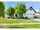 Charming home featuring a white brick exterior, well-manicured lawn, and an attached two-car garage at 6897 Abercon Trl, Noblesville, IN 46062
