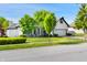 Attractive home showcasing a white brick exterior, an attached garage, and mature trees in the yard at 6897 Abercon Trl, Noblesville, IN 46062