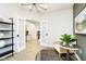 Bright entryway with white French doors, modern light fixture, and stylish decor on a black shelving unit at 7242 Barrett Dr, Brownsburg, IN 46112