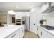 Modern kitchen featuring white cabinets, stainless steel appliances, an island, and sleek countertops at 7242 Barrett Dr, Brownsburg, IN 46112
