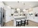 Bright, modern kitchen with white cabinetry, stainless steel appliances, and a center island with stool seating at 7242 Barrett Dr, Brownsburg, IN 46112
