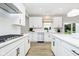 Bright, contemporary kitchen featuring white cabinets, stainless steel appliances, and a center island with breakfast bar at 7242 Barrett Dr, Brownsburg, IN 46112
