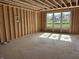 Unfinished room with wood framing and window showcasing abundant natural light at 7242 Barrett Dr, Brownsburg, IN 46112