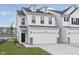Charming two-story home features a two-car garage, black roof, dormers and well-manicured front yard at 7318 Shroyer Way, Noblesville, IN 46062