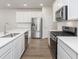 Modern kitchen featuring stainless steel appliances, white cabinets, quartz countertops, and a stylish backsplash at 7318 Shroyer Way, Noblesville, IN 46062