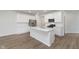 Well-lit kitchen with stainless steel appliances, a large island, and plenty of white cabinets at 7318 Shroyer Way, Noblesville, IN 46062