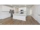 Contemporary kitchen boasts a large center island, stainless steel appliances, and ample white cabinetry at 7318 Shroyer Way, Noblesville, IN 46062
