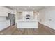 Bright, open kitchen with stainless steel appliances, white cabinetry, large center island, and hard surface flooring at 7318 Shroyer Way, Noblesville, IN 46062