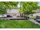 Large backyard featuring a spacious deck, patio with a fire pit, and lush greenery for outdoor living at 7345 Monon Cir, Indianapolis, IN 46256