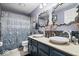 Bathroom featuring double sinks, decorative mirrors, and stylish shower curtain at 7345 Monon Cir, Indianapolis, IN 46256