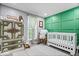 Stylish Bedroom with a crib, accent wall, and decorative furniture at 7345 Monon Cir, Indianapolis, IN 46256