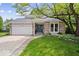 Charming ranch-style home with brick facade, attached garage, and mature landscaping at 7345 Monon Cir, Indianapolis, IN 46256