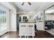 Bright kitchen with white cabinets, an island with bar stools, and modern appliances at 7345 Monon Cir, Indianapolis, IN 46256