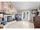 Inviting living room with brick fireplace, and a bright window at 7345 Monon Cir, Indianapolis, IN 46256