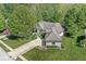 Stunning aerial view of a brick home featuring lush landscaping and a spacious driveway at 7421 Meadow Violet Ct, Avon, IN 46123