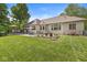 Spacious backyard featuring a brick home, deck, patio and beautiful landscaping at 7421 Meadow Violet Ct, Avon, IN 46123