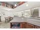 Basement area featuring counter space, microwave, and view into open living area at 7421 Meadow Violet Ct, Avon, IN 46123
