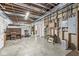 Unfinished basement with exposed beams, concrete floor, and vintage piano adds unique charm at 7421 Meadow Violet Ct, Avon, IN 46123