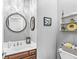 Elegant powder room with dark wood vanity, stylish mirror, chandelier, and a tiled floor at 7421 Meadow Violet Ct, Avon, IN 46123