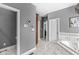 Bright bathroom with gray walls, white trim, and a soaking tub at 7421 Meadow Violet Ct, Avon, IN 46123