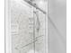 Modern bathroom shower with gray marbled walls and sleek fixtures at 7421 Meadow Violet Ct, Avon, IN 46123